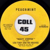 Lou Toby And His Heavies – Heavy Steppin’ b/w Steel, Jake And Jeff – The Impeachment Story – Peach-Mint 7″