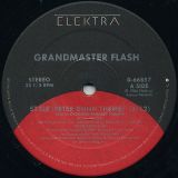 Grandmaster Flash – Style (Peter Gunn Theme) b/w Edit Of LP Version AND Instrumental Version – Elektra 12″