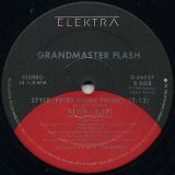Grandmaster Flash – Style (Peter Gunn Theme) b/w Edit Of LP Version AND Instrumental Version – Elektra 12″